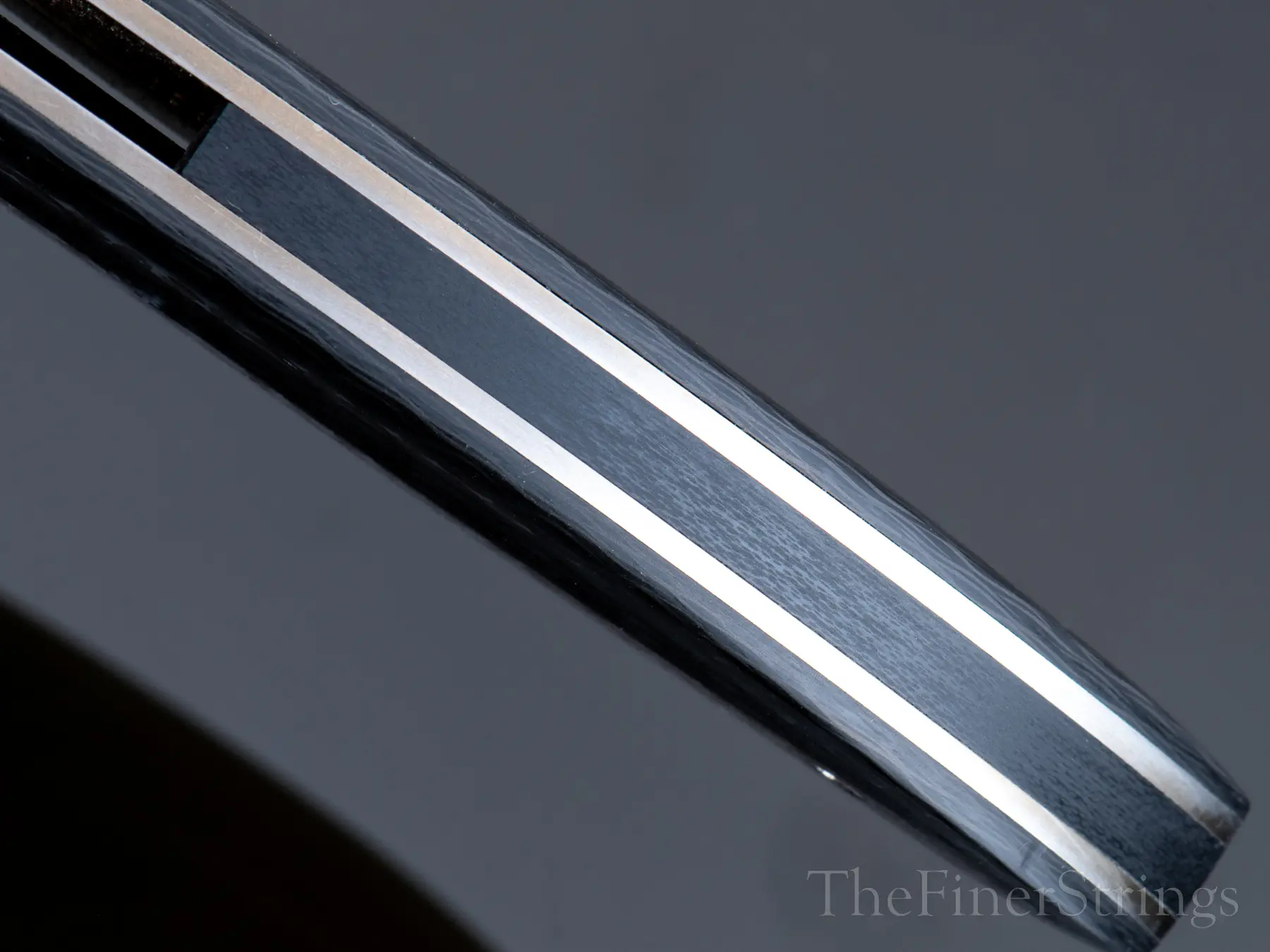 Spine — carbon fiber with stainless liner stripe