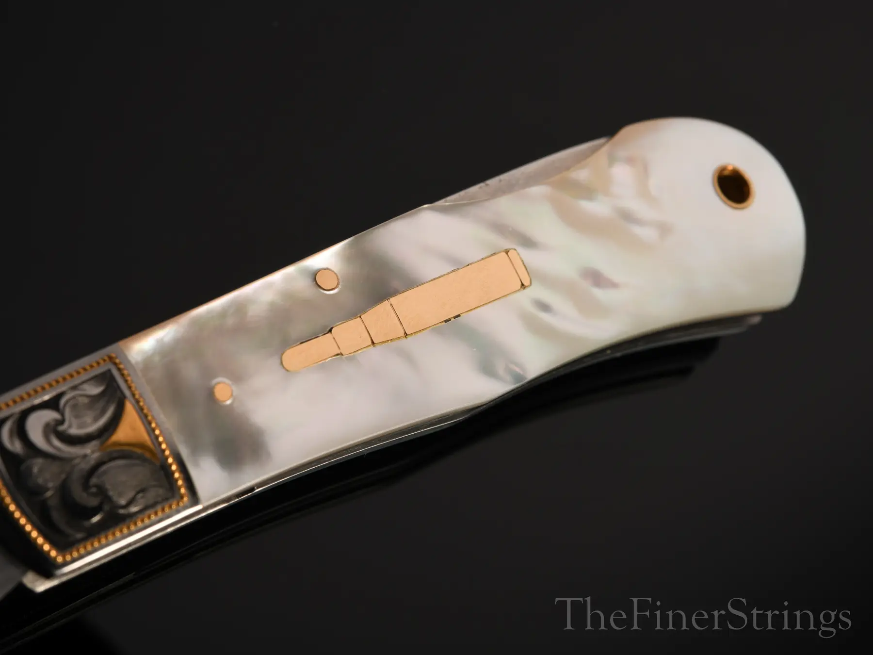 Handle detail — mother of pearl and gold inlay