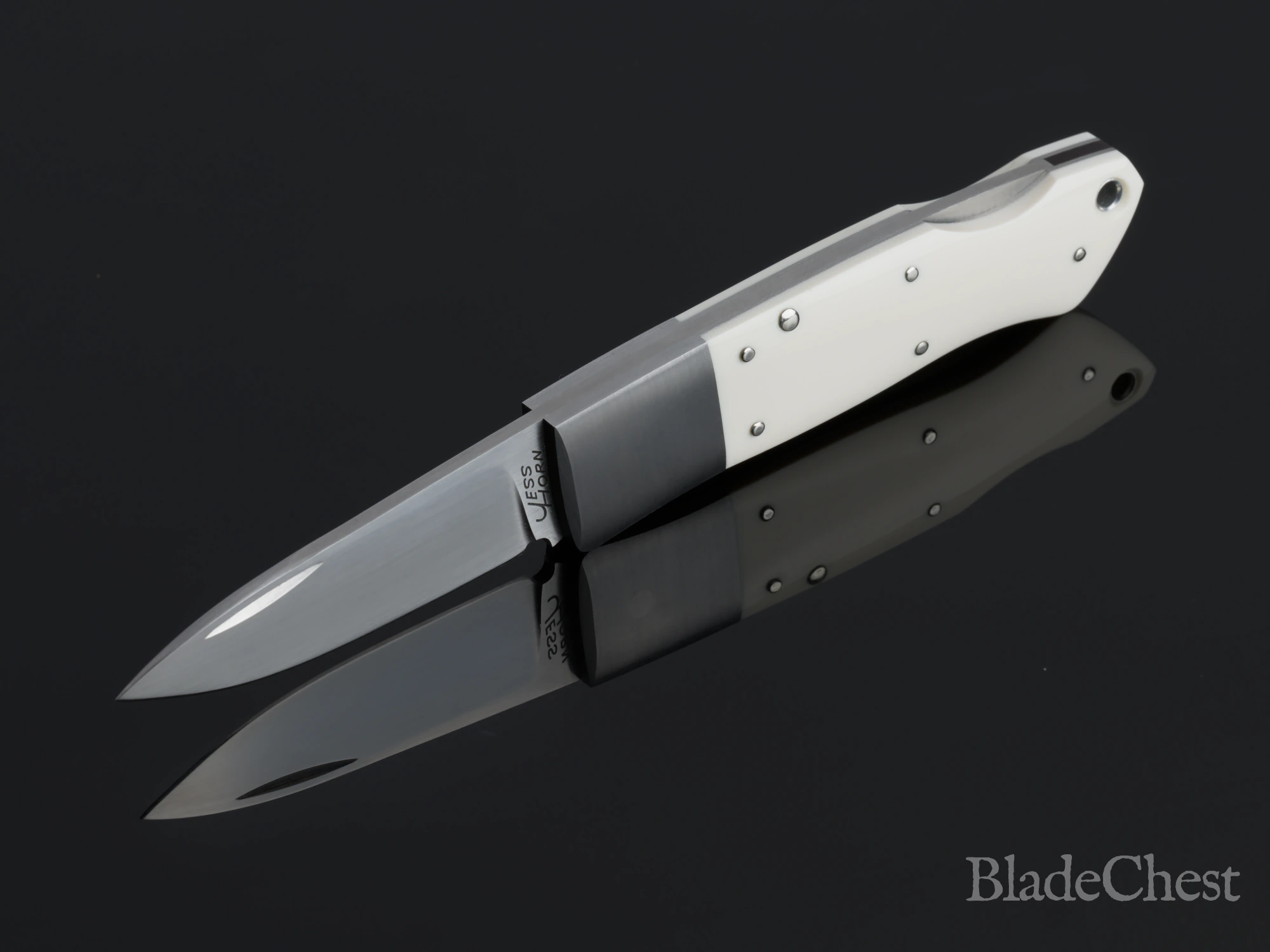 Jess Horn mammoth ivory lockback &mdash; open, dramatic plunge, blade down-left