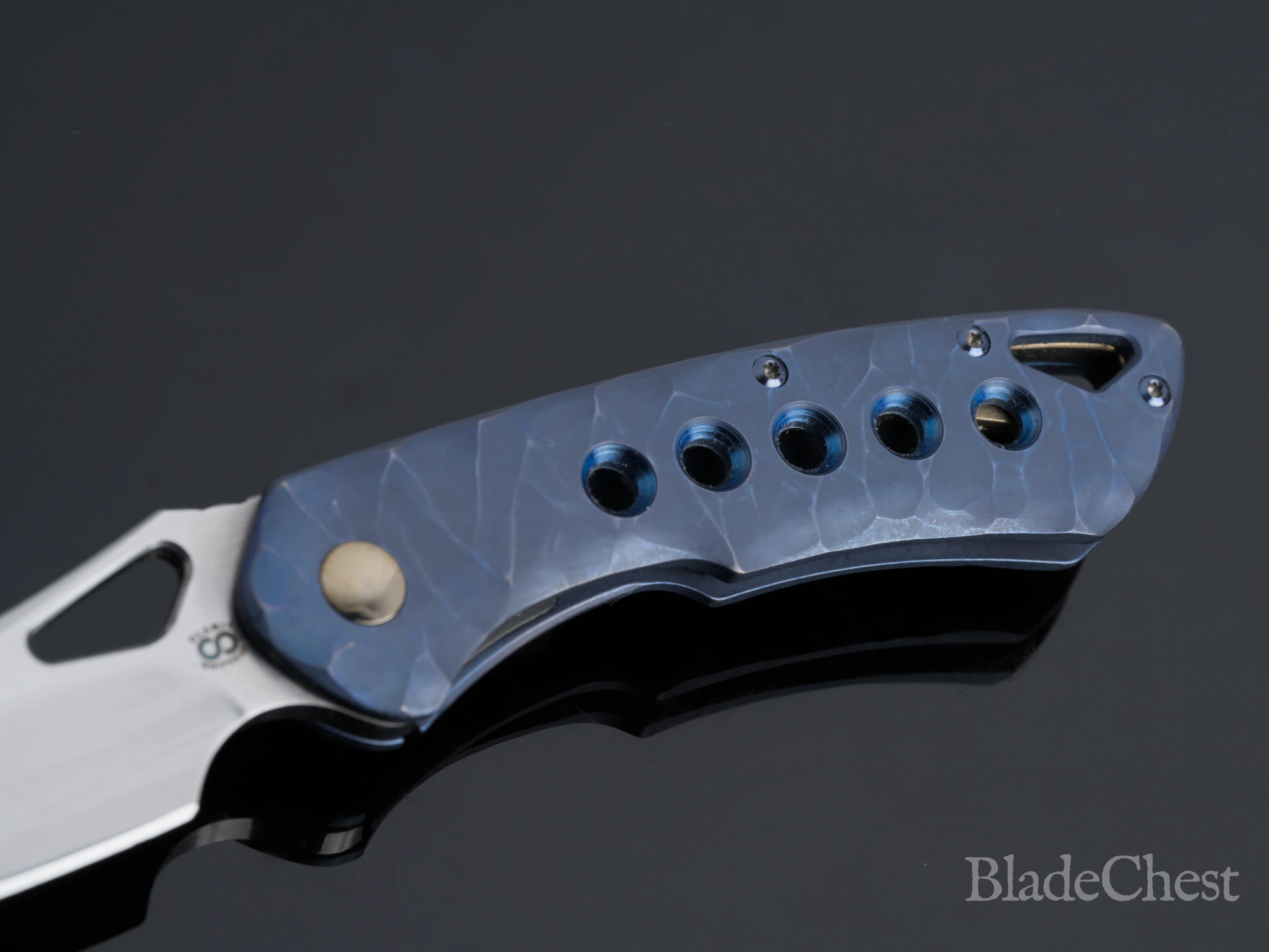 Olamic Whippersnapper &mdash; open, sculpted blue titanium frame and blue hardware