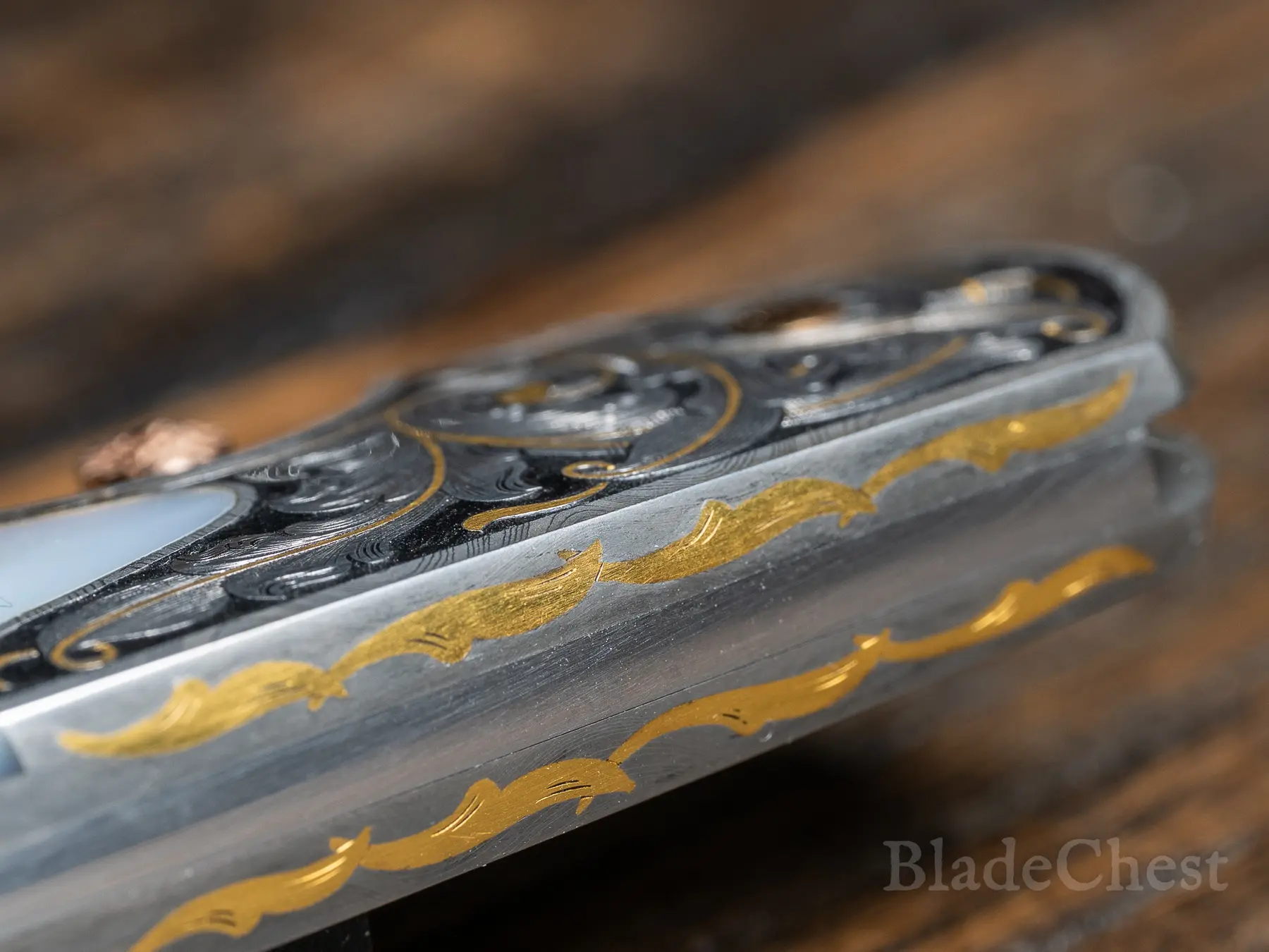Spine edge — 24k gold inlay running the full length