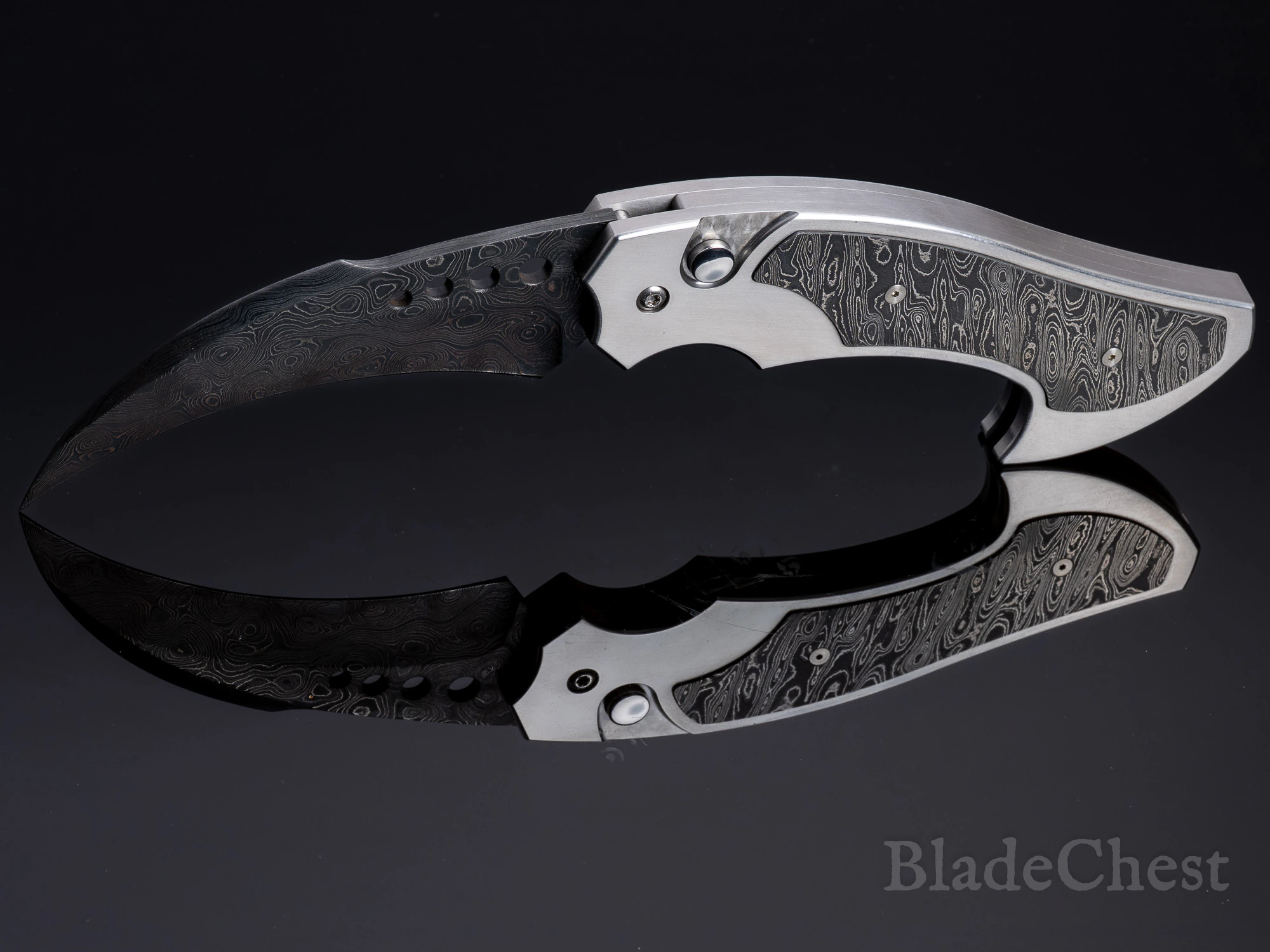 Reese Weiland automatic &mdash; the curved hawkbill Damascus blade