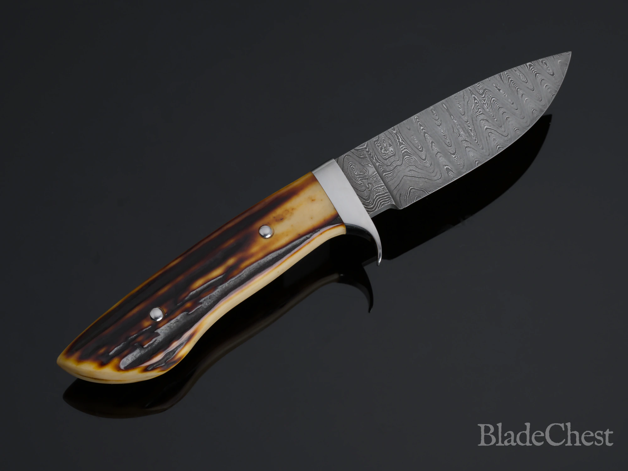 Mike Williams Drop Point Hunter &mdash; the wave Damascus pattern across the drop-point blade